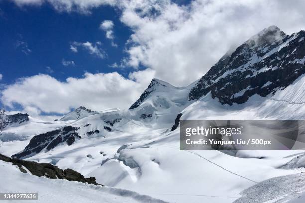 scenic view of snow covered mountains against sky,interlaken,switzerland - interlaken ストックフォトと画像