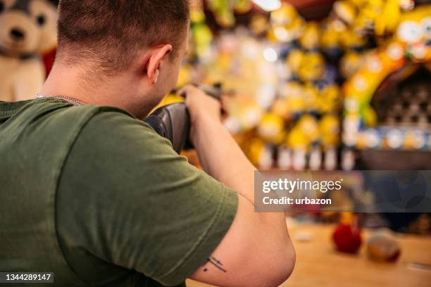 shooter at a shooting gallerie - air rifle stock pictures, royalty-free photos & images