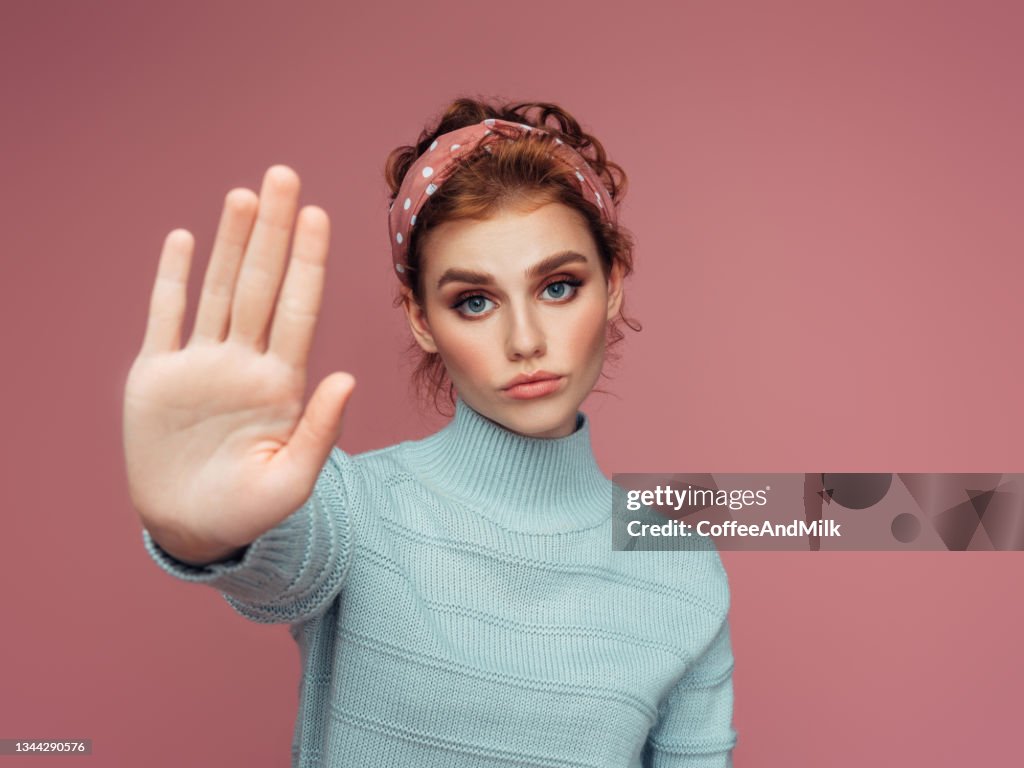 Nahaufnahme eines jungen hübschen Mädchens mit Stoppschild