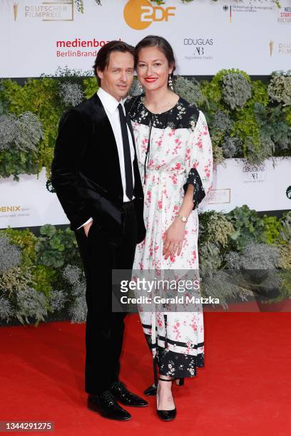 Tom Schilling and Annie Mosebach arrive for the Lola - German Film Award at Palais am Funkturm on October 01, 2021 in Berlin, Germany.