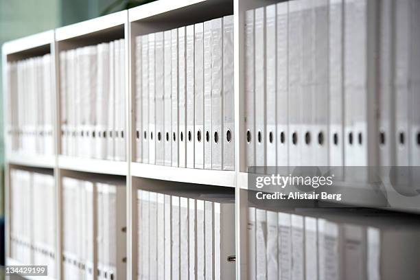 files on shelves in an office - sala de arquivos imagens e fotografias de stock