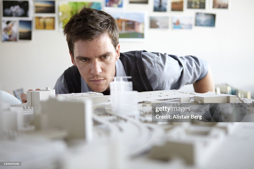 Architect studying model