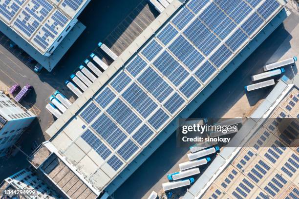 solar panels on factory rooftop - modern warehouse stock pictures, royalty-free photos & images