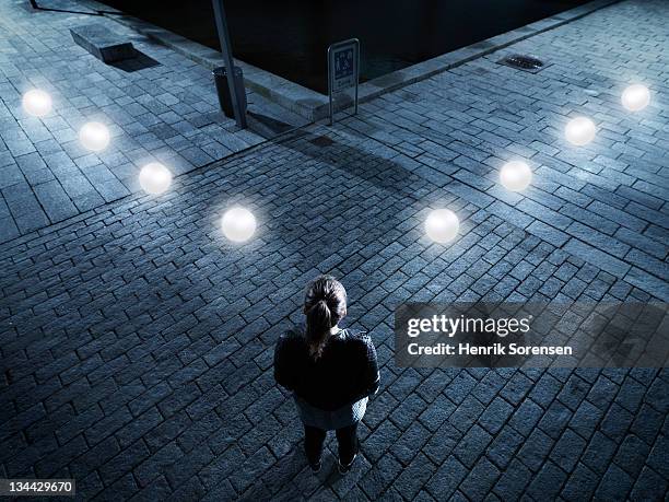 young woman in front of gaming icons - woman capturing city night foto e immagini stock