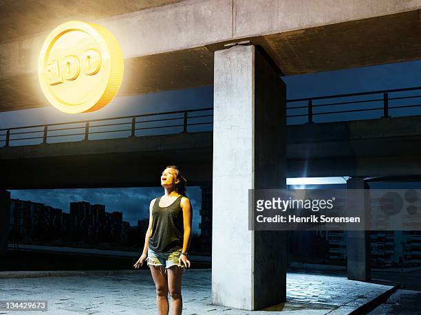 young woman in urban  environment looking at coin - 100 bildbanksfoton och bilder