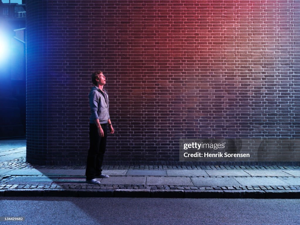 Young man in the street looking up