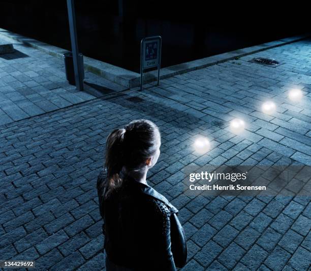 young woman in front of glowing balls - woman capturing city night stockfoto's en -beelden