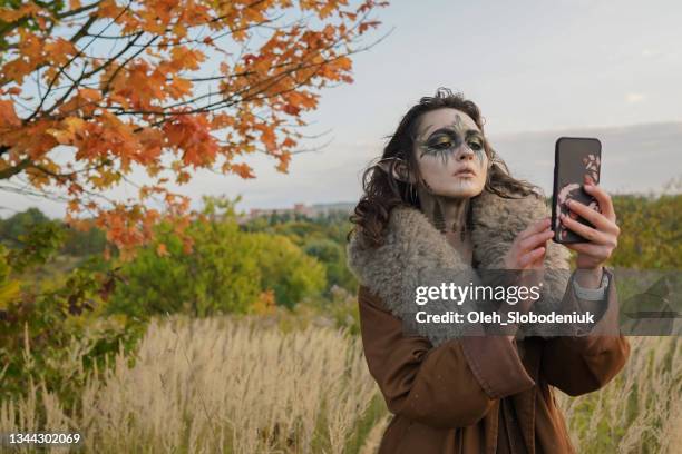 woman in halloween elf costume   taking selfie in the forest - vestido sin mangas imagens e fotografias de stock