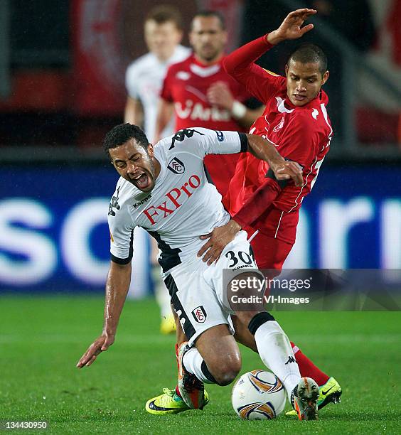 Moussa Dembele of Fulham clashes with Roberto Rosales of FC Twente during the Europa League match between FC Twente and Fulham FC at the Grolsch...