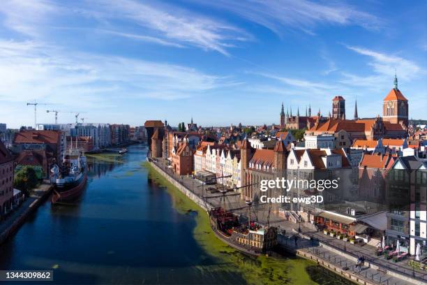 the classic view of gdansk old town with historical  ships on the river motlawa, poland - gdansk poland stockfoto's en -beelden