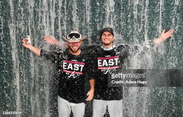 Minter of the Atlanta Braves and Luke Jackson of the Atlanta Braves celebrate in the center field water fall after winning the NL Eastern Division...