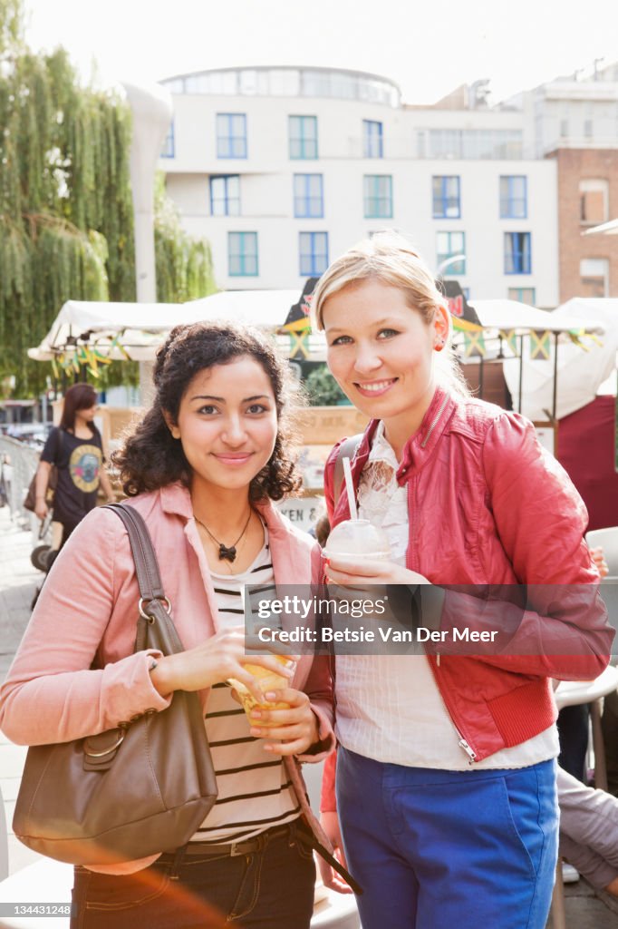 Portrait of female friends at market.