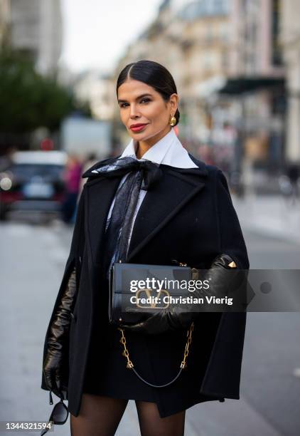 Victoria Barbara is seen on her way to Valentino wearing total look Valentino, black cape, gloves, bag, white blouse, sheer tights, heels, sunglasses...