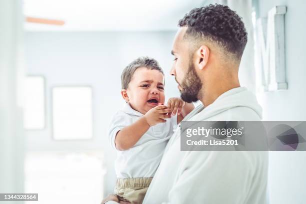 african american mixed race father tries to console his cranky toddler son - toddler tantrum stock pictures, royalty-free photos & images