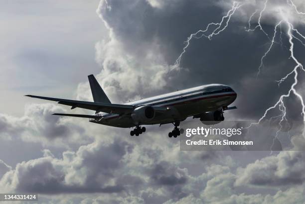 a boeing 777 wide body airliner landing at miami international airport during a lightning storm. - boeing 777 foto e immagini stock