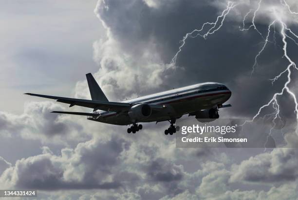 a boeing 777 wide body airliner landing at miami international airport during a lightning storm. - boeing 777 stock pictures, royalty-free photos & images