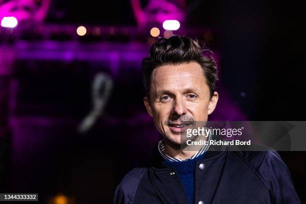 Dj Martin Solveig poses in front of the Eiffel Tower during the «Octobre Rose» by Ruban Rose show as part of Breast Cancer Awareness month during...