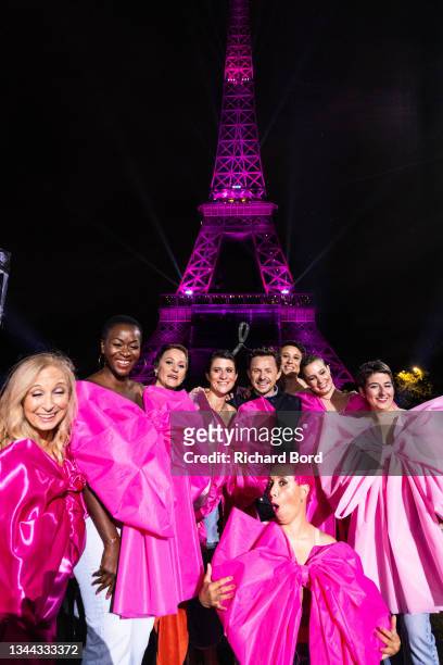 Dj Martin Solveig poses with women with breast cancer in front of the Eiffel Tower during the «Octobre Rose» by Ruban Rose show as part of Breast...