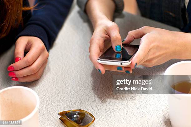 close up of a women looking at her mobile phone - blue nail polish stock pictures, royalty-free photos & images