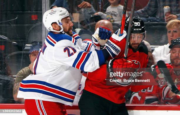 Barclay Goodrow of the New York Rangers hits Tomas Tatar of the New Jersey Devils into the glass during the first period in a preseason game at the...
