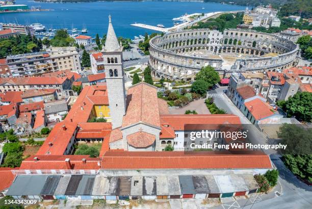 church of saint anthony & roman amphitheater (pula arena), pula, istria, croatia - pula croatia stock pictures, royalty-free photos & images