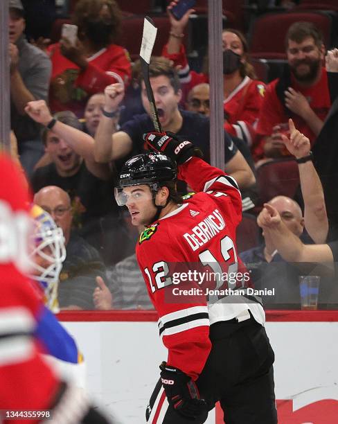 Alex DeBrincat of the Chicago Blackhawks celebrates a second period goal against the St. Louis Blues during a preseason game at the United Center on...