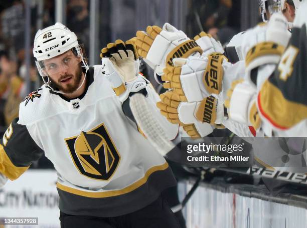 Daniil Miromanov of the Vegas Golden Knights celebrates with teammates on the bench after scoring a first-period goal against the Los Angeles Kings...