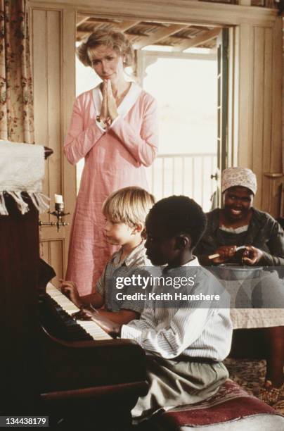 Child actor Guy Witcher as the 7-year-old P.K., American actress Tracy Brooks Swope as his mother, Nomadlozi Kubheka as Nanny and Tonderai Masenda as...