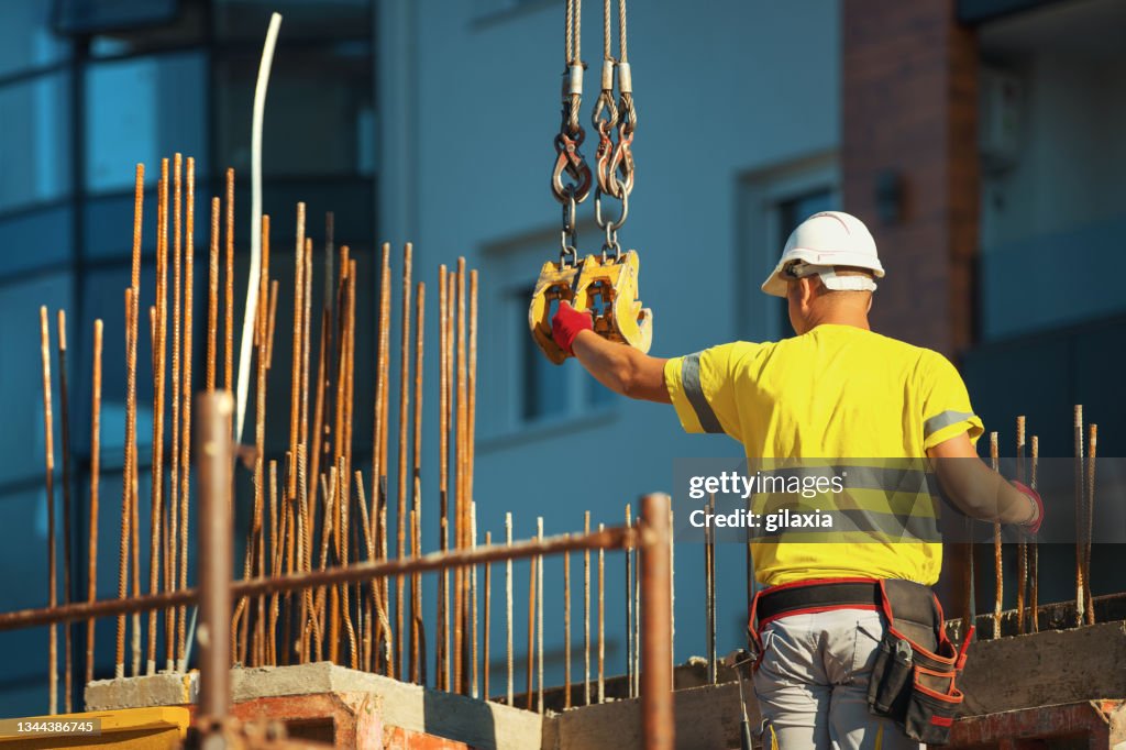 Construction worker loading cargo onto a construction crane