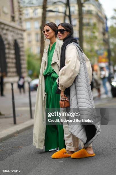 Gilda Ambrosio wears black sunglasses, a white t-shirt, a black puffy scarf, a half beige oversized puffy sleeves and half pale gray quilted...