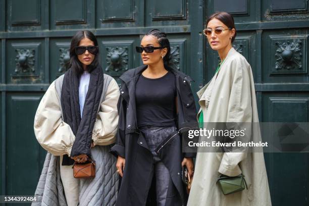 Gilda Ambrosio wears black sunglasses, a white t-shirt, a black puffy scarf, a half beige oversized puffy sleeves and half pale gray quilted...