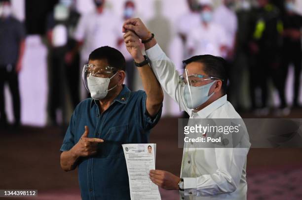 Philippine Senator Christopher "Bong" Go , accompanied by Philippine President Rodrigo Duterte, files his certificate of candidacy to join the vice...
