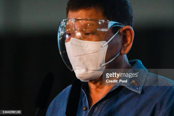 Philippine President Rodrigo Duterte speaks to the media after Philippine Senator Christopher "Bong" Go filed his certificate of candidacy to join...
