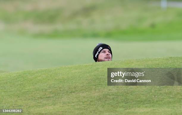 Tyrrell Hatton of England plays his second shot from a deep fairway bunker on the second hole during the third round of The Alfred Dunhill Links...