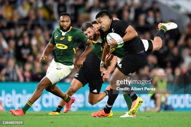 Rieko Ioane of the All Blacks is tackled during The Rugby Championship match between the South Africa Springboks and New Zealand All Blacks at Cbus...