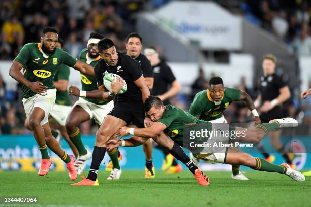 Rieko Ioane of the All Blacks is tackled during The Rugby Championship match between the South Africa Springboks and New Zealand All Blacks at Cbus...