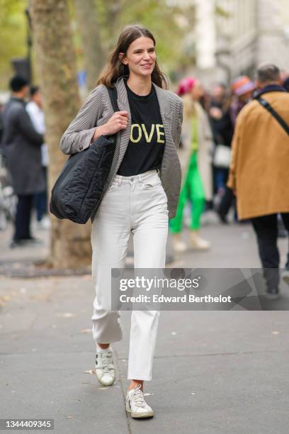 Guest wears a black with yellow Love slogan inscription t-shirt, a black and white houndstooth print pattern blazer jacket, a black oversized puffy...