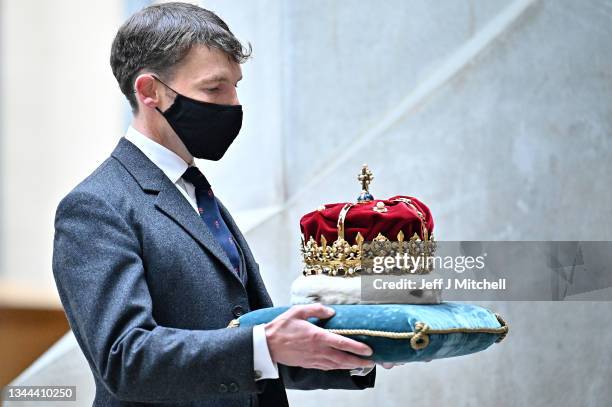 The Duke of Hamilton carries The Crown of Scotland accompanied with Officers of Arms, the Royal Company of Archers and young people from Scottish...