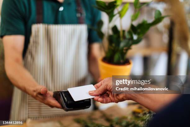 a quick touch away from buying a perfect plant - card payments stock pictures, royalty-free photos & images