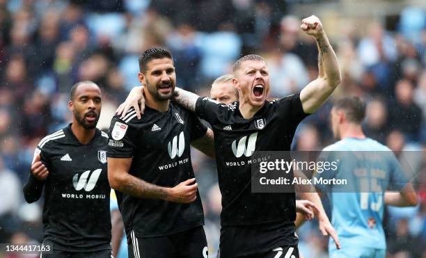 Aleksandar Mitrovic and Alfie Mawson of Fulham celebrate after their side's first goal, an own goal scored by Kyle McFadzean during the Sky Bet...