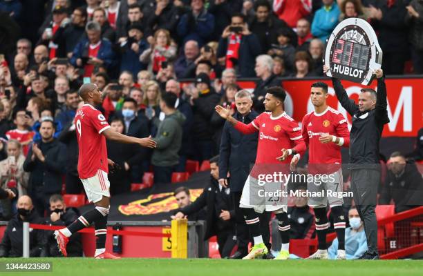 Jadon Sancho and Cristiano Ronaldo of Manchester United wait to take to the field as substitutes during the Premier League match between Manchester...