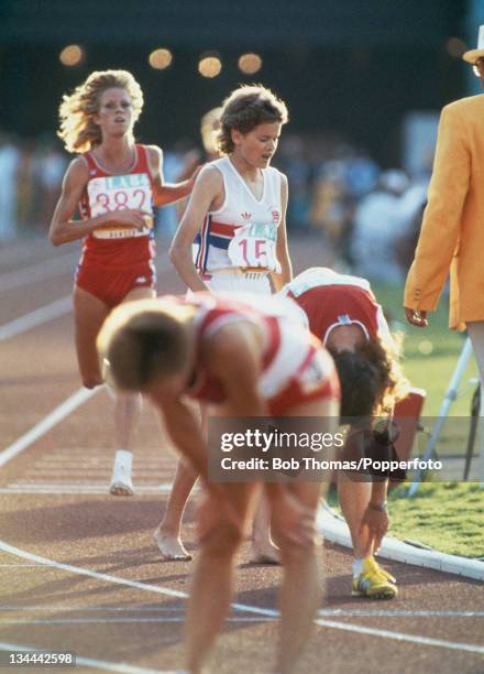 Athletes Zola Budd of Great Britain and Joan Hansen of the United States cross the finish line in 7th and 8th place in the final of the Women's 3000...
