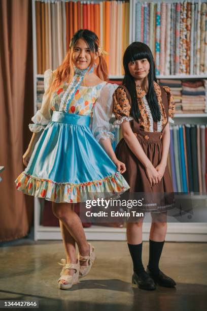 portrait of women dress up in cosplay costume and wig in clothing store looking at camera posing and smiling - anime cosplay stock pictures, royalty-free photos & images