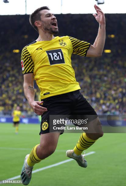 Raphael Guerreiro of Borussia Dortmund celebrates after scoring their team's first goal from the penalty spot during the Bundesliga match between...