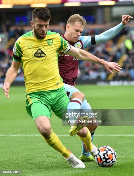 Grant Hanley of Norwich City is challenged by Matej Vydra of Burnley during the Premier League match between Burnley and Norwich City at Turf Moor on...