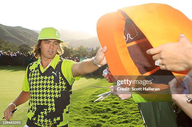 Rickie Fowler signs autographs for fans during the first round of the Chevron World Challenge at Sherwood Country Club on December 1, 2011 in...