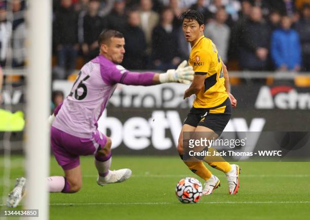 Hwang Hee-chan of Wolverhampton Wanderers scores their side's first goal past Karl Darlow of Newcastle United during the Premier League match between...