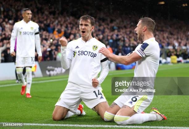 Diego Llorente celebrates with teammate Liam Cooper of Leeds United after scoring their team's first goal during the Premier League match between...