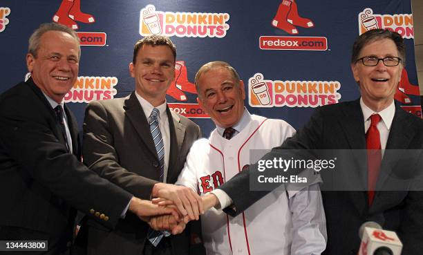 Team owners Larry Lucchino, left, and John Henry, far right, and vice president and general manager Ben Cherington, center, pose with Bobby Valentine...