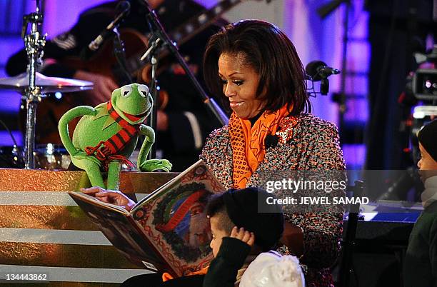 First Lady Michelle Obama is joined by Kermit the Frog, from the Muppets movie, as she reads a story during the 2011 National Christmas Tree Lighting...
